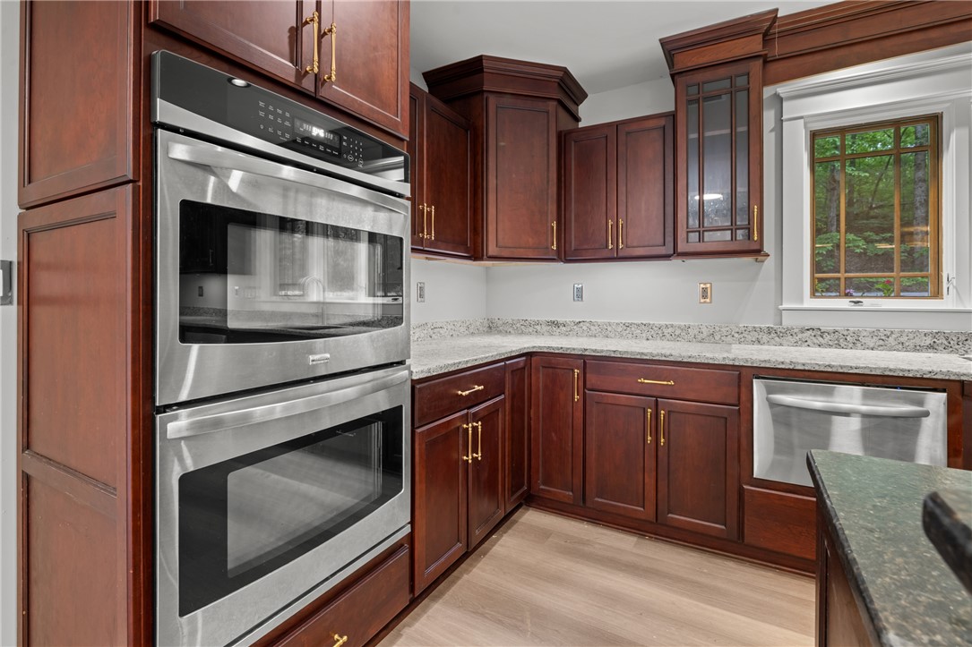 309 Woodland Way Clemson, SC 29631 - Photo 6 of 43 This modern kitchen features rich cabinetry, sleek stainless steel appliances, and ample counter space.