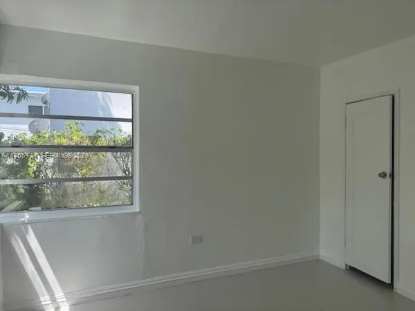 a bathroom with a window and a shower