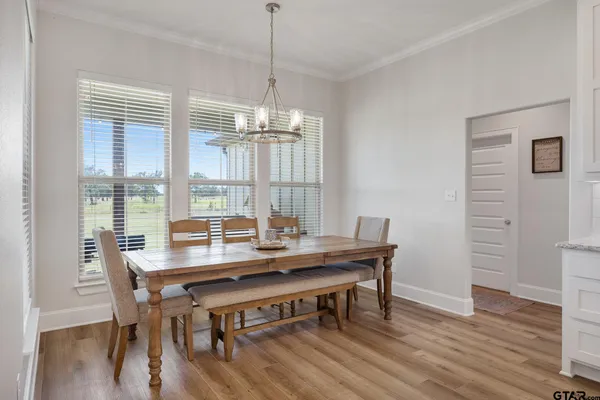 a bathroom with a white tub a double vanity sink and a mirror