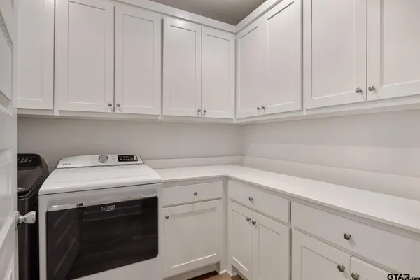 a front view of a house with a garden and yard