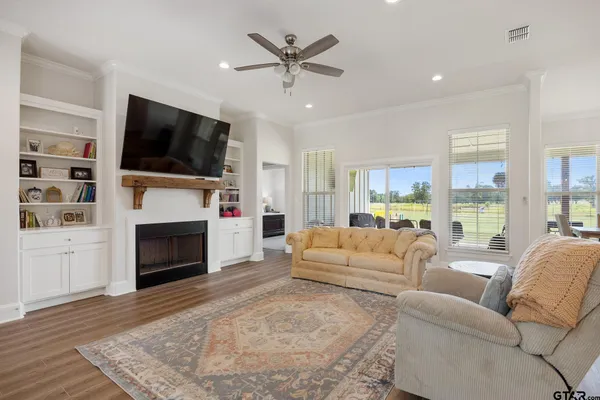 a living room with furniture a flat screen tv and a fireplace