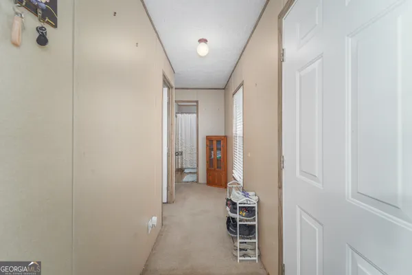 a view of a hallway with wooden shelves
