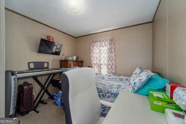 a bedroom with a bed and a tv