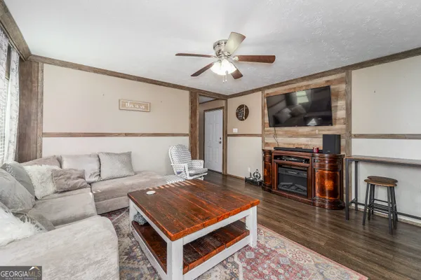 a living room with furniture and a flat screen tv