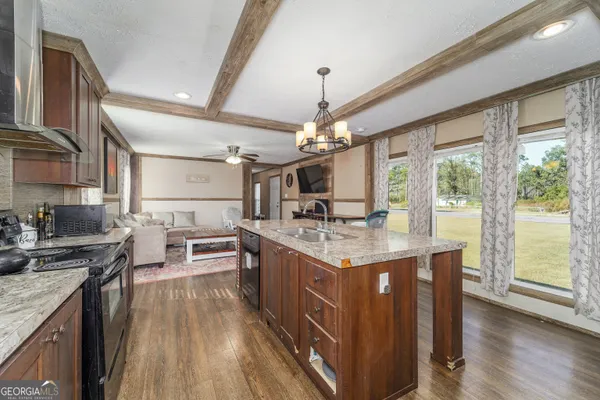 a kitchen with stainless steel appliances granite countertop a stove oven and a refrigerator
