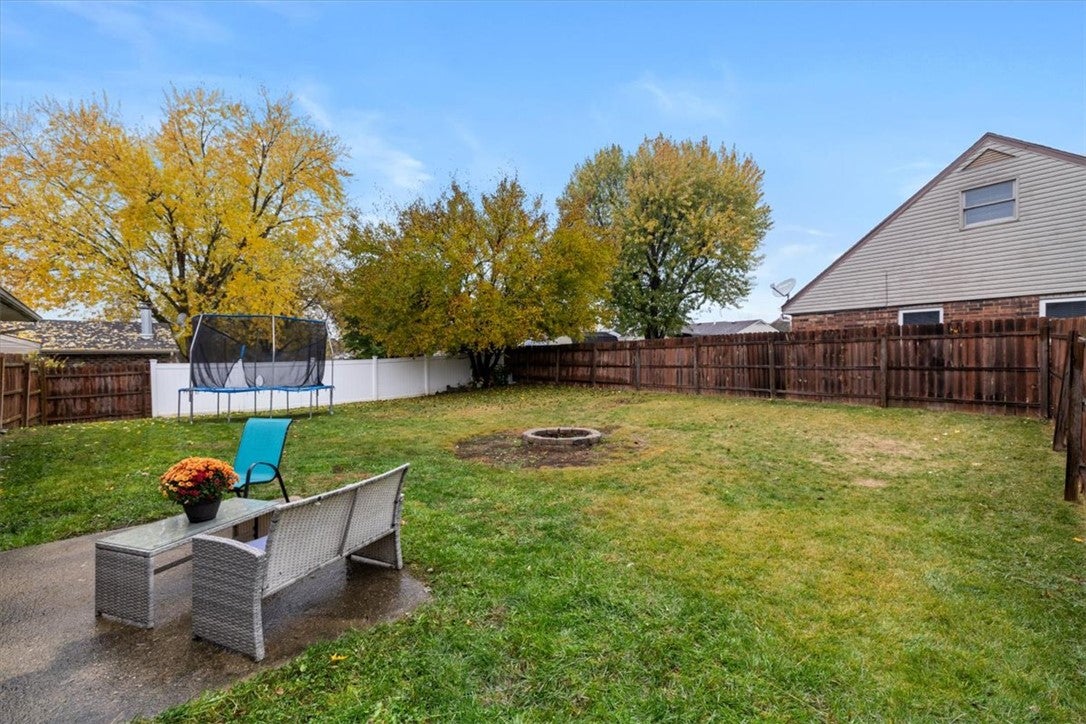 1482 Lee Road Troy, OH 45373 - Photo 24 of 30 This spacious yard features a fire pit and a privacy fence, perfect for outdoor enjoyment.