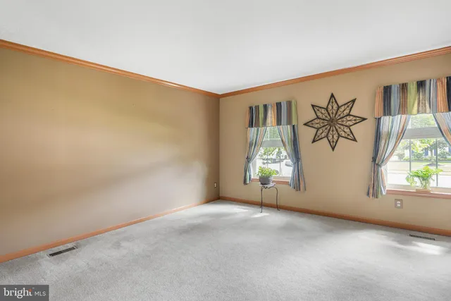 an empty room with windows and entrance