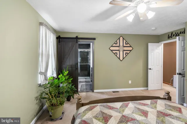 a bedroom with a bed and a potted plant