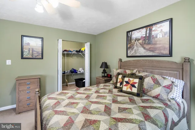 a bed sitting in a bedroom and painting on the wall