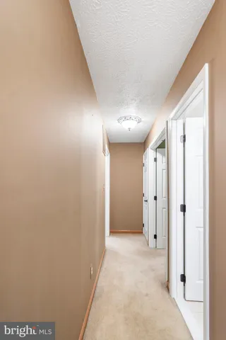a view of hallway with a bathroom