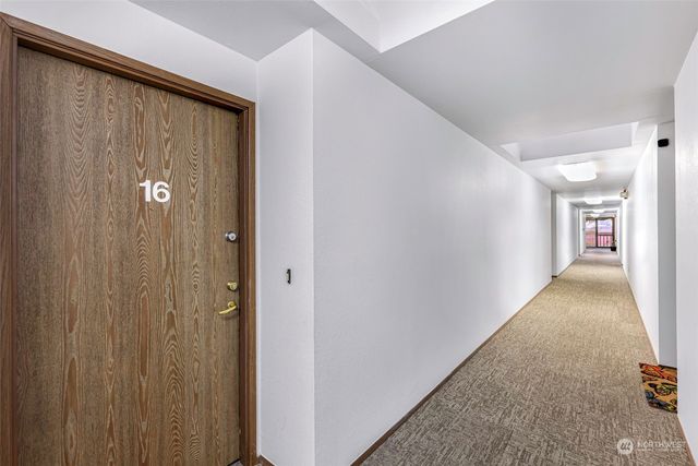 a view of a hallway with wooden shelves