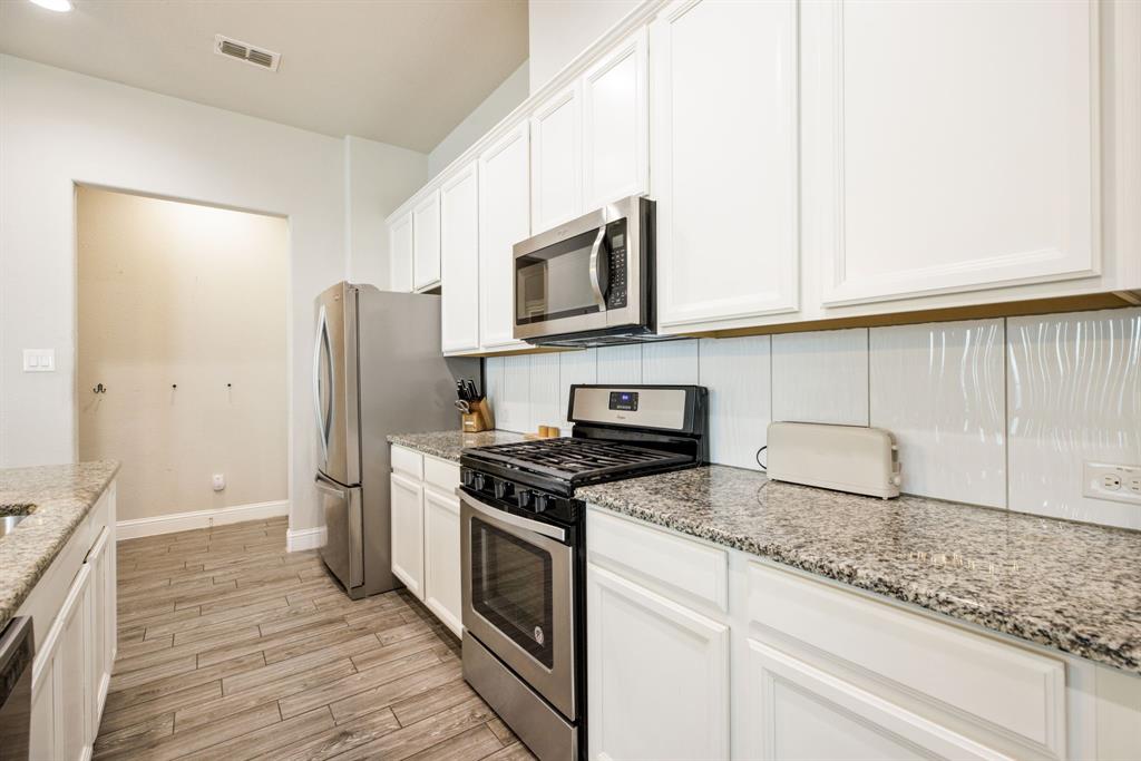 620 Ansley Way Allen, TX 75013 - Photo 16 of 31 a kitchen with stainless steel appliances granite countertop a stove a refrigerator and a microwave