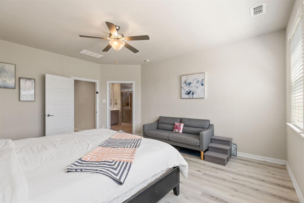 620 Ansley Way Allen, TX 75013 - Photo 19 of 31 a bedroom with a bed and a chandelier