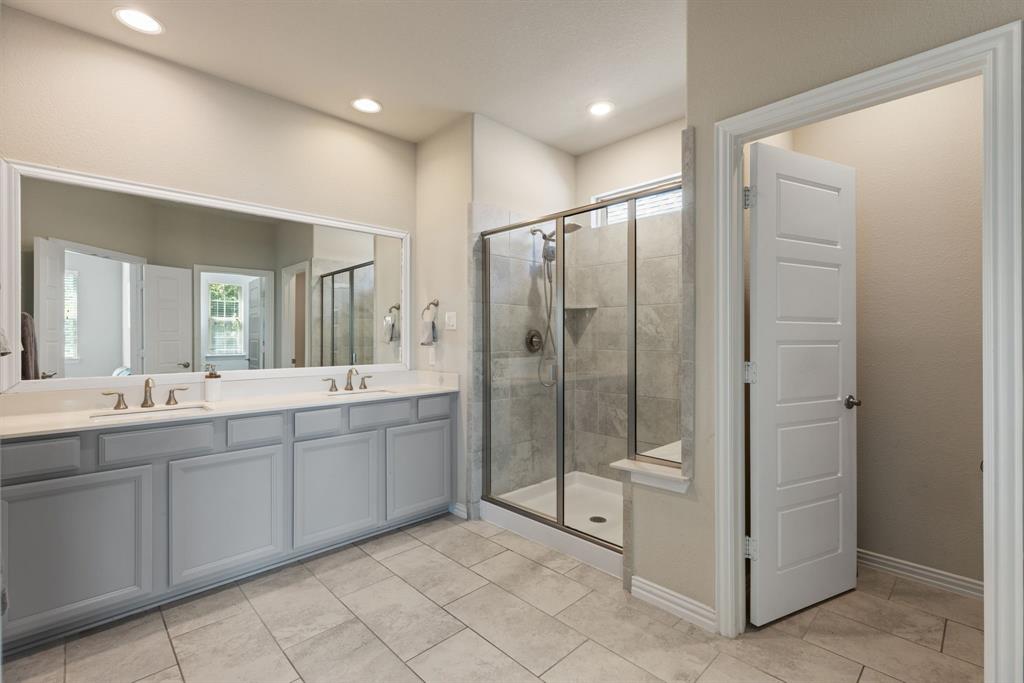 620 Ansley Way Allen, TX 75013 - Photo 20 of 31 a bathroom with a double vanity sink and mirror