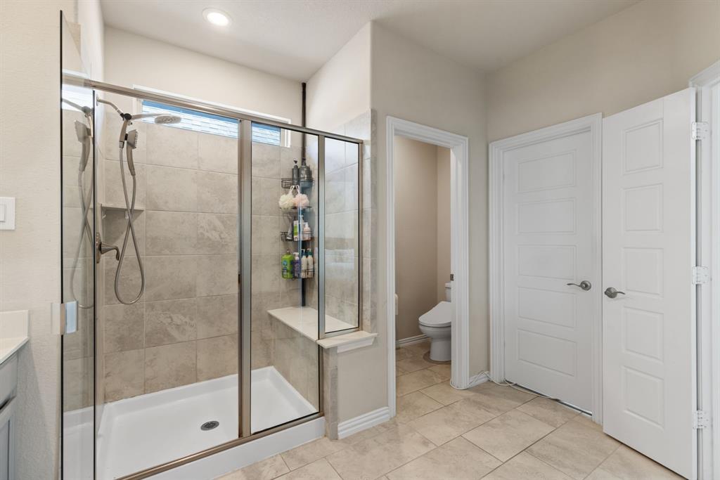 620 Ansley Way Allen, TX 75013 - Photo 21 of 31 a bathroom with a shower and a glass door