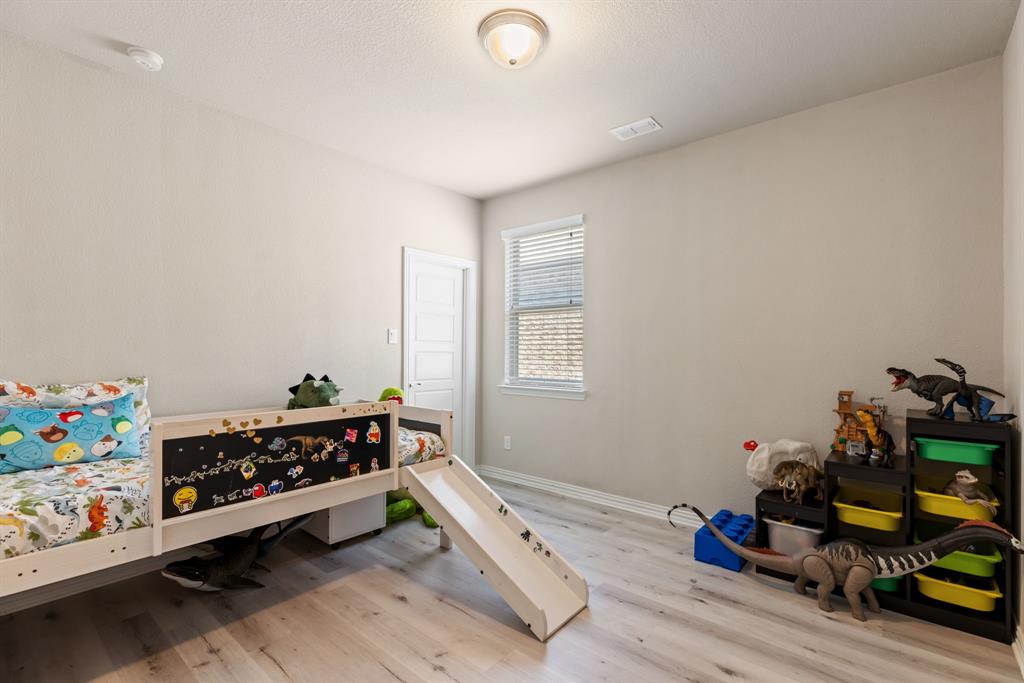 620 Ansley Way Allen, TX 75013 - Photo 25 of 31 a room with toys and wooden floor