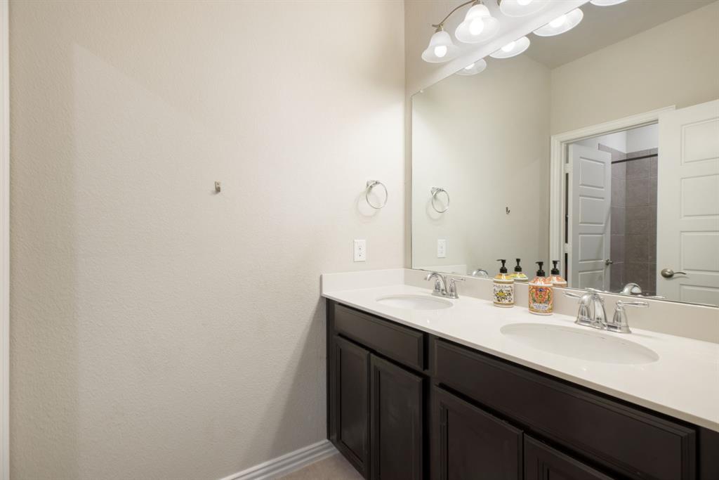 620 Ansley Way Allen, TX 75013 - Photo 27 of 31 a bathroom with a sink a light fixture and a mirror