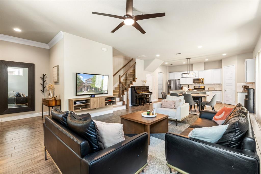 620 Ansley Way Allen, TX 75013 - Photo 5 of 31 a living room with fireplace furniture and a wooden floor