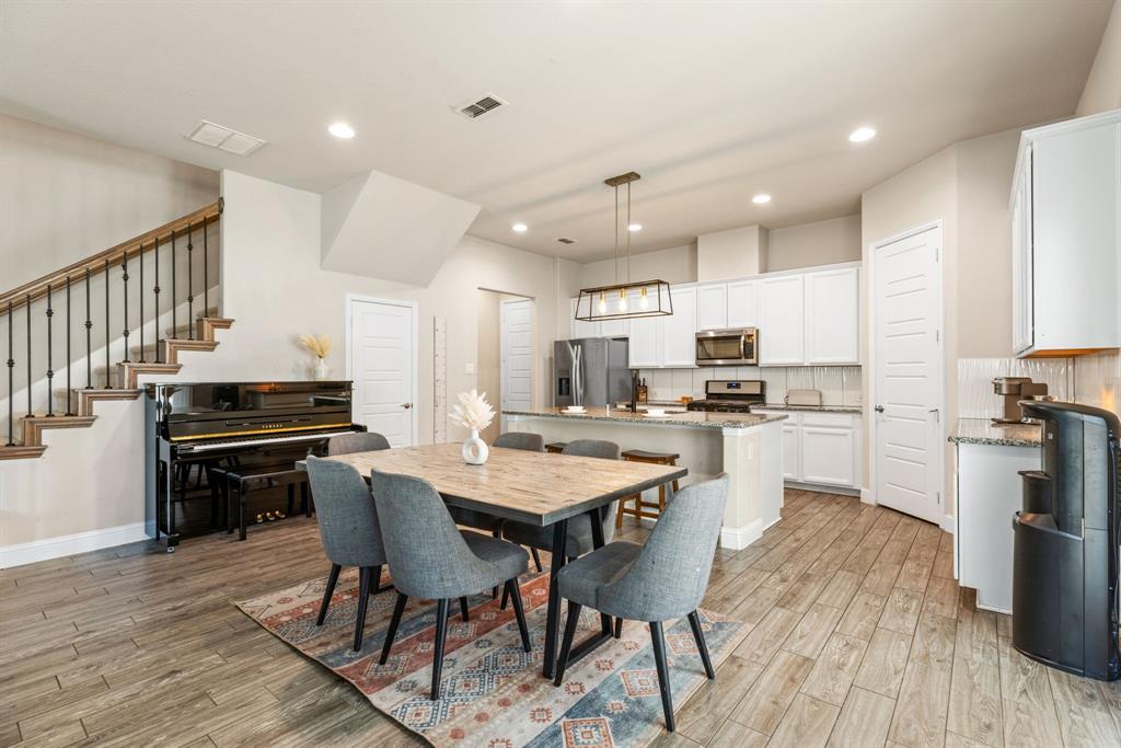 620 Ansley Way Allen, TX 75013 - Photo 8 of 31 a kitchen with a dining table chairs and refrigerator