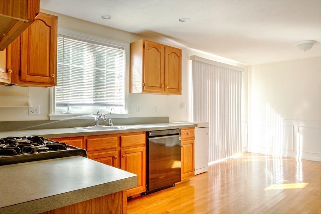 1278 Trapelo Road Waltham, MA 02451 - Photo 6 of 42 a kitchen with stainless steel appliances a sink a stove and a refrigerator