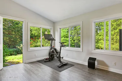 a view of a room with gym equipment and a floor to ceiling window