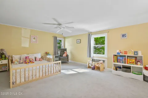 a bedroom with furniture and a book shelf