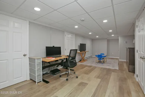 a view of a workspace with furniture and a window