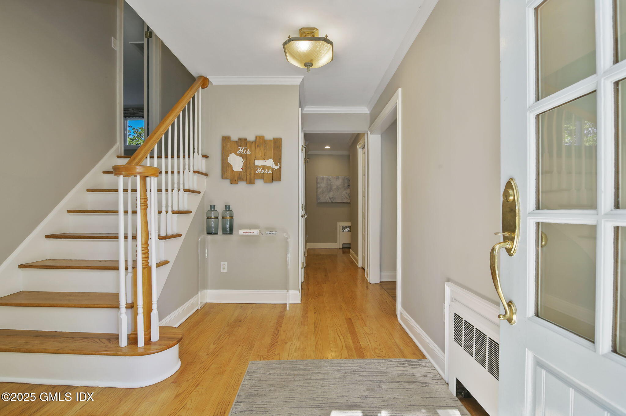 7 Pleasant View Place Old Greenwich, CT 06870 - Photo 2 of 22 a view of a hallway with wooden floor and staircase