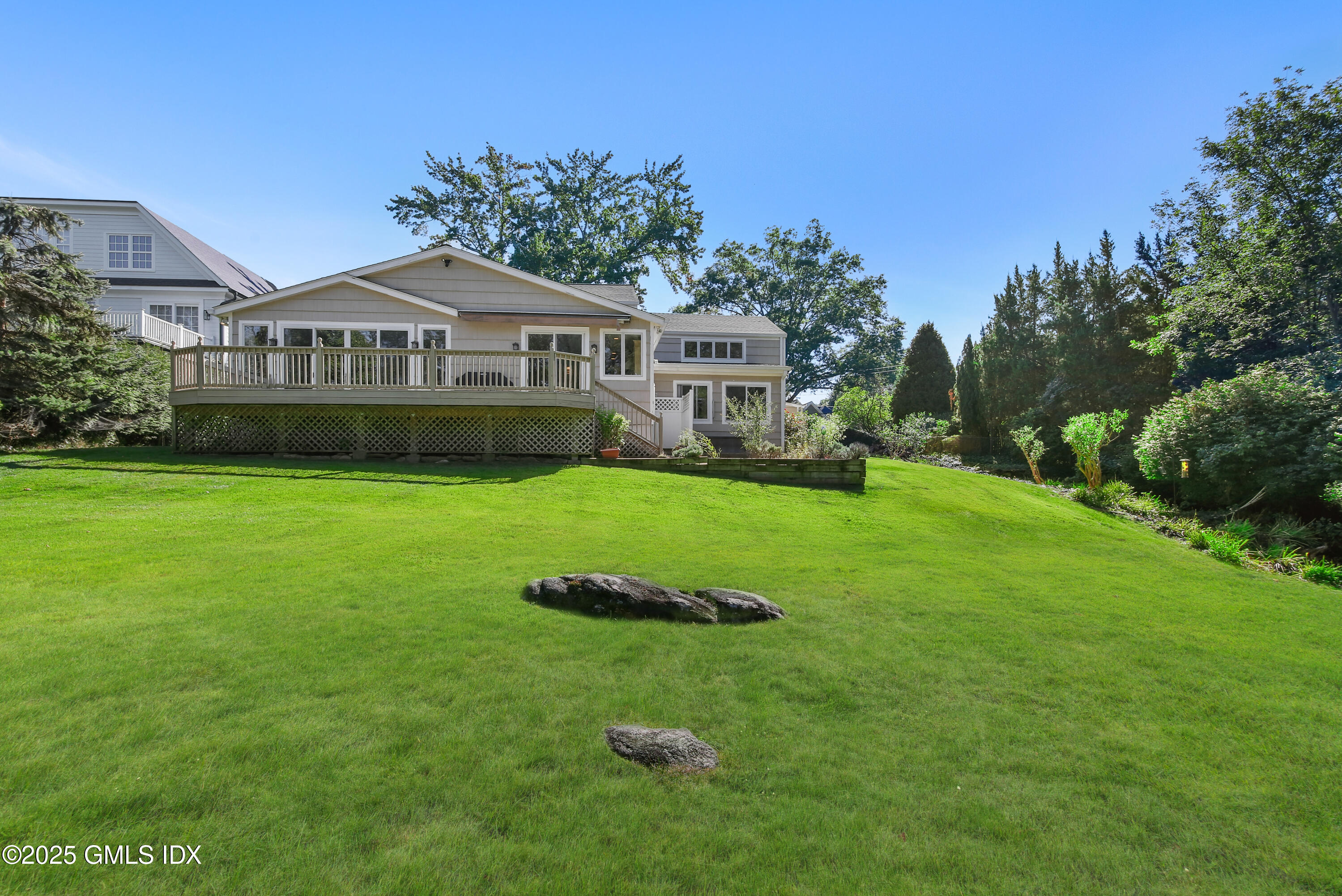 7 Pleasant View Place Old Greenwich, CT 06870 - Photo 21 of 22 a front view of a house with a yard table and chairs