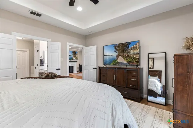 a view of a house with a big yard and large tree