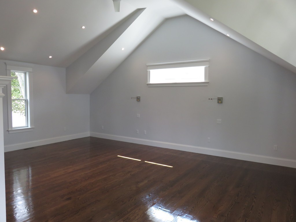 12 Maple Street Newton, MA 02466 - Photo 11 of 28 an empty room with wooden floor and windows