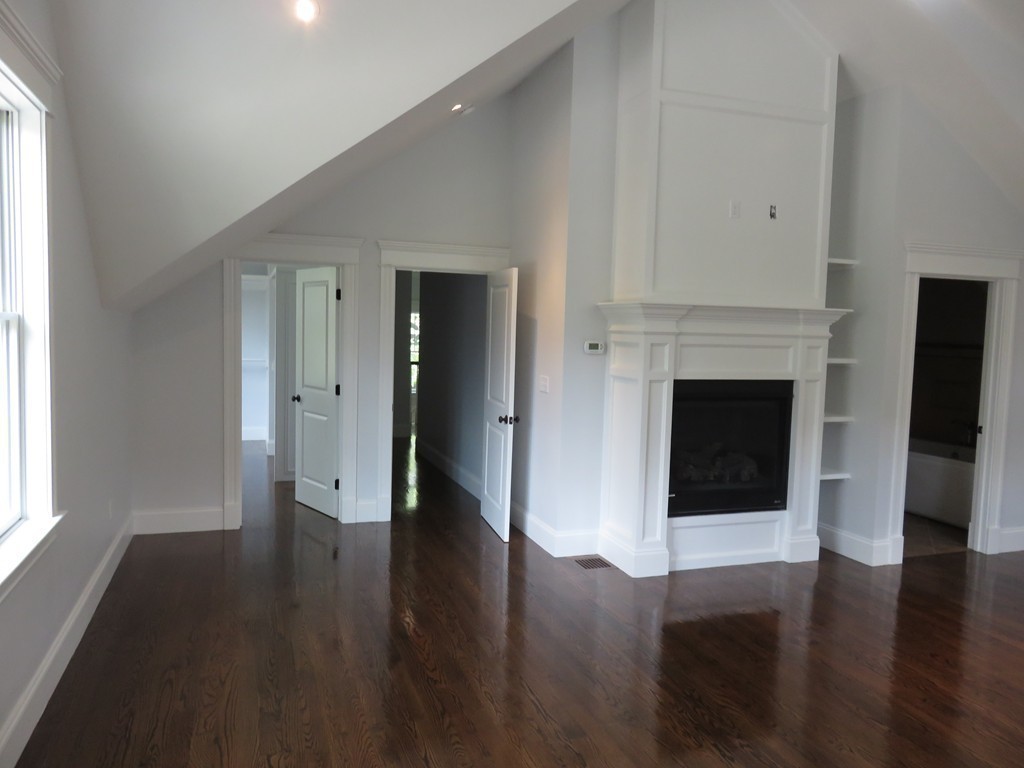 12 Maple Street Newton, MA 02466 - Photo 13 of 28 a view of a hallway with wooden floor and a fireplace