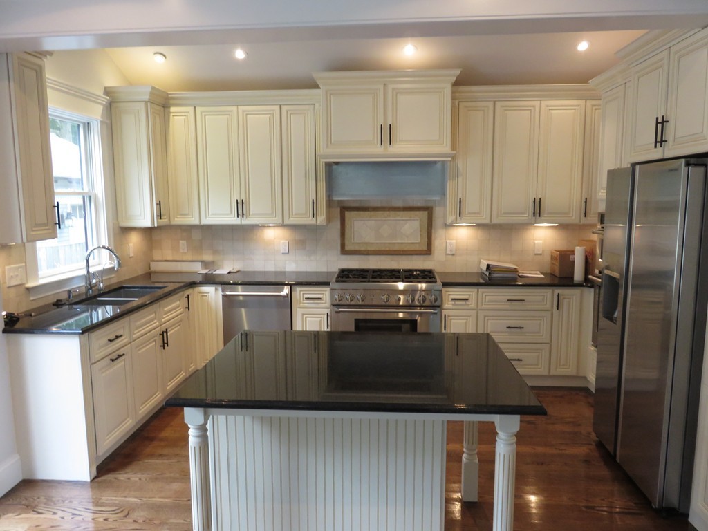 12 Maple Street Newton, MA 02466 - Photo 3 of 28 a kitchen with granite countertop a refrigerator stove and sink