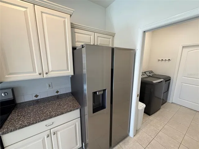 a kitchen with a refrigerator and a sink