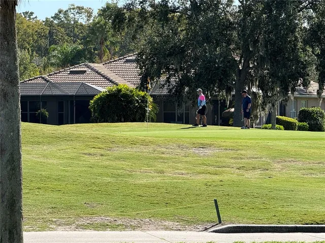a view of swimming pool is middle in the garden