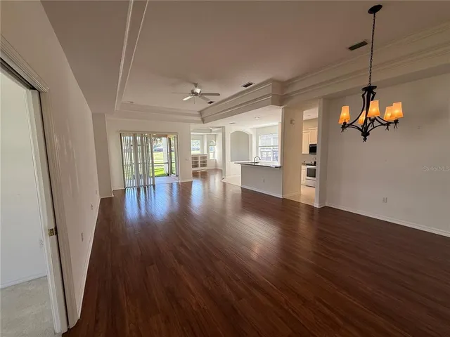 a view of a room with wooden floor and windows