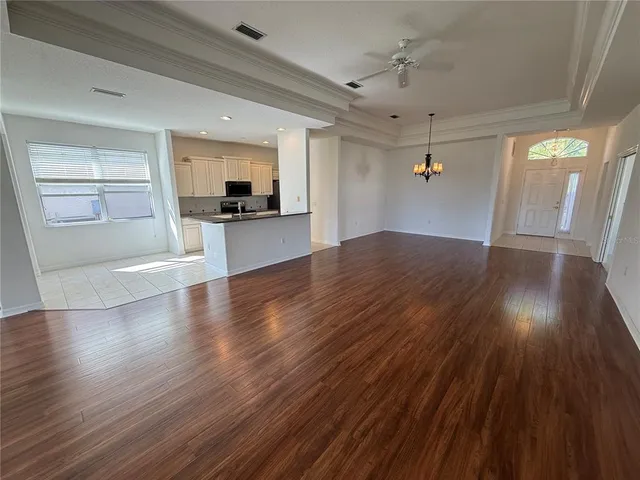 a view of a kitchen with wooden floor and a kitchen