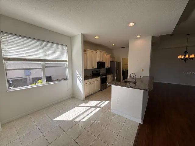 a large white kitchen with a large window