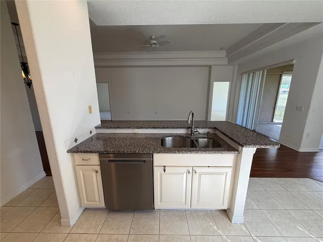 a kitchen with stainless steel appliances granite countertop a sink and a stove