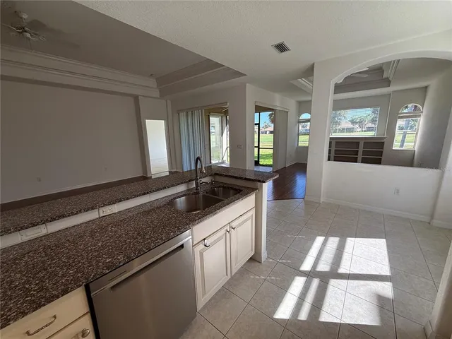 a large white kitchen with a large window