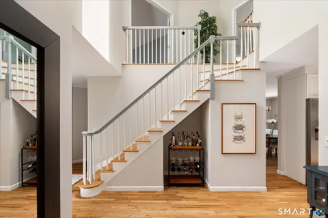 a view of entryway and hall with wooden floor