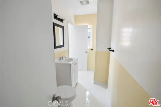 a bathroom with a sink a toilet and mirror