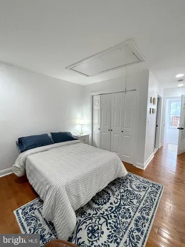 a bedroom with a large bed and a rug