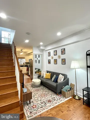 a living room with furniture and wooden floor