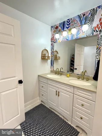a bathroom with a sink a vanity and a mirror