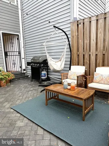 a balcony with furniture and next to a window