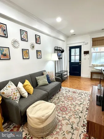 a living room with furniture and painting on the wall