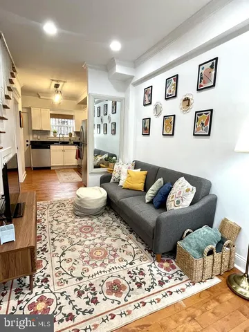 a living room with furniture and a rug