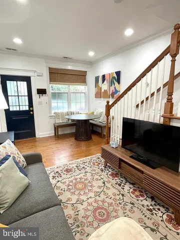 a living room with a couch a rug and a flat screen tv