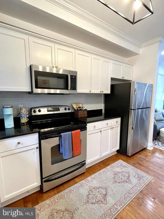 1656 Kramer Street Northeast Washington, DC 20002 - Photo 8 of 29 a kitchen with stainless steel appliances granite countertop a refrigerator stove a sink and a microwave